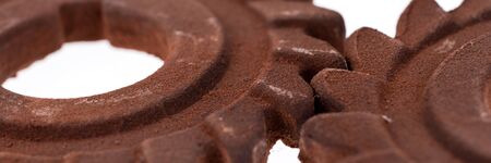 Panoramic image. Two incredible rusty chocolate gears isolated on whiteの写真素材