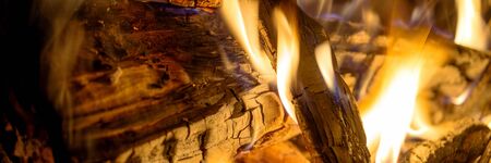 Panoramic image firewood bonfire is blazing. Burning wood fight in the night darknessの写真素材