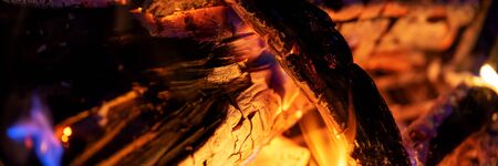 Panoramic image firewood bonfire is blazing. Burning wood fight in the night darkness