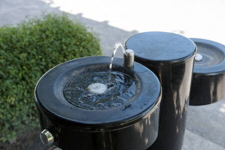 Drinking fountain black stainless steel drink liquid water wet refreshmentの写真素材
