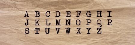 Alphabet written with an old typewriter on old paper sheet. Panoramic imageの写真素材