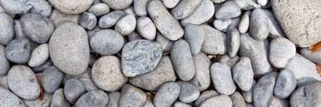 Round gray gravel pattern. Abstract background texture. Top view. Panoramic image