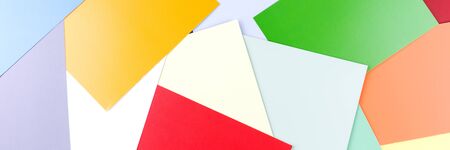 Panoramic background of colored paper. Many sheets of colored paper