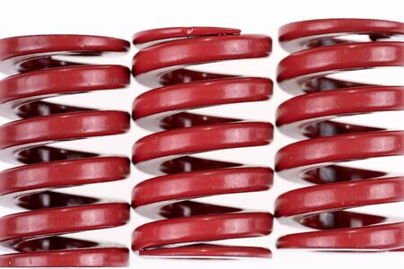 Closeup three red strong metal springs isolated on a white background