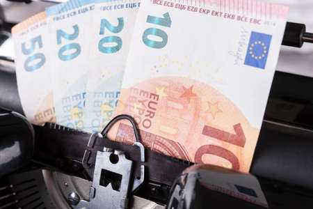 Vintage typewriter printing Euro bills, make money conceptの写真素材