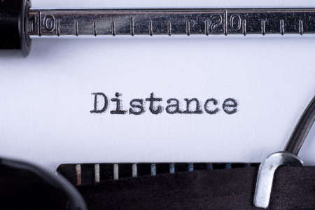 Distance on white sheet in vintage typewriterの写真素材