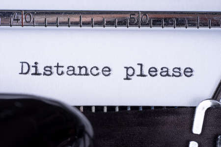 Distance please on white sheet in vintage typewriter