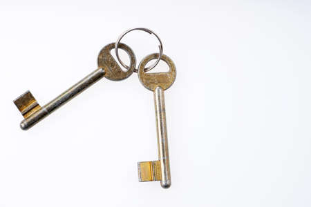 Two old simple front door keys isolated on white
