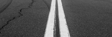 Asphalt background with two white road lines. Road markings on asphalt