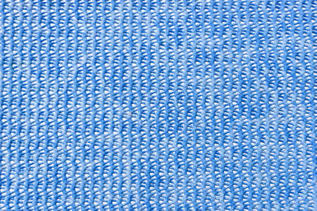 Blue plastic background with holes. Blue pattern