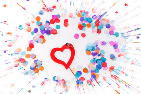 Colorful confetti with a red heart in the middleの写真素材