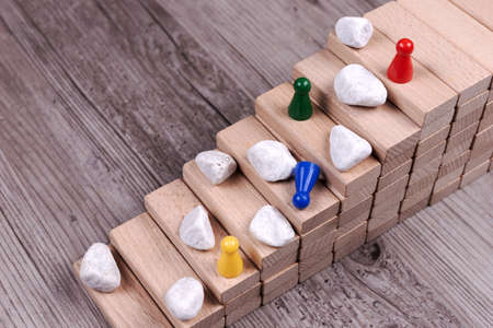 Difficult climb up the career ladder. Stones are in the way up the stairs