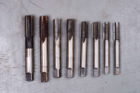 Set of different thread taps on colored wooden backgroundの写真素材