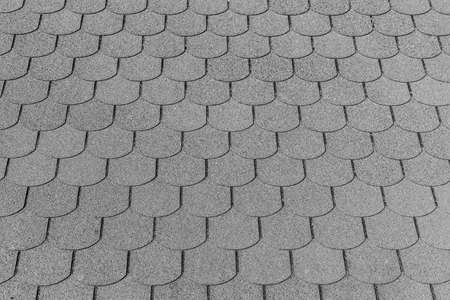 Closeup detail of black bitumen shingles on a roofの写真素材