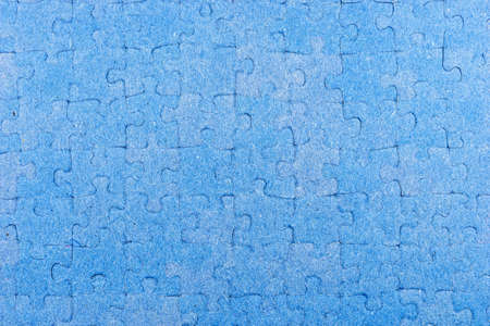 Jigsaw puzzle as background. Closeup of blue jigsaw puzzle piecesの写真素材