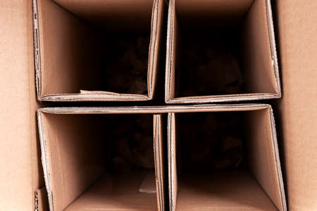 Closeup brown cardboard box with dividers. Glass bottle transport boxの写真素材