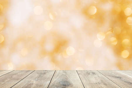 Wooden table top on blur abstract yellow background. Yellow background with bokeh light