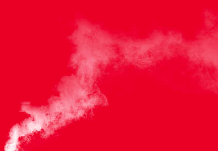 White smoke swirls on the red backgroundの写真素材
