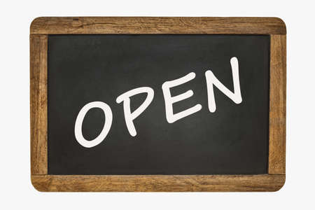 Open, written on a black chalk board with a wooden frame
