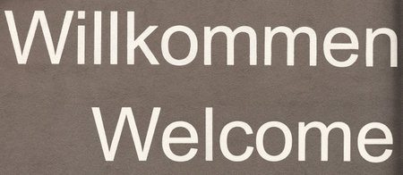 Welcome in German and English. Words on the wall. Panoramic imageの写真素材