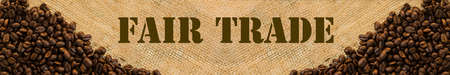 Dark roasted fair trade coffee beans with text Fair Trade. Panoramic imageの写真素材