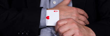 Card ace of hearts in the sleeve of the black suit. Panoramic imageの写真素材