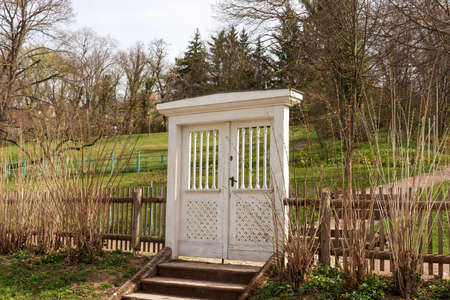 Large white wooden gate leading into the gardenの写真素材