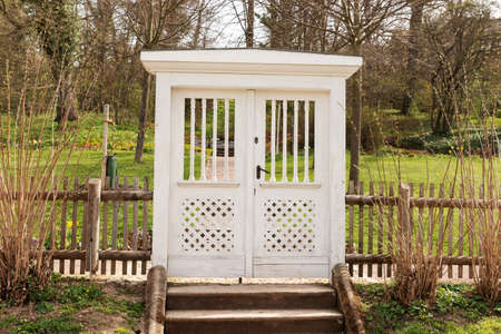 Large white wooden gate leading into the gardenの写真素材