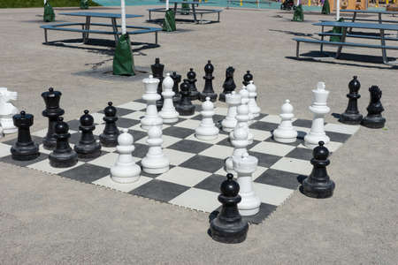 Outdoor large chess. Chess pieces. Outdoor entertainment and games
