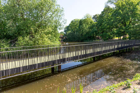 New iron bridge over the pond in the parkの写真素材