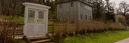 Large white wooden gate leading into the garden. Panoramic imageの写真素材