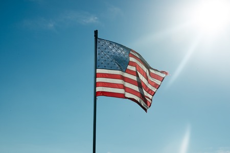 Flag of the United States of America with sunflare