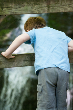 Boy looking at Crabtree Falls along the Blue Ridge Parkway near Asheville North Carolinaの写真素材