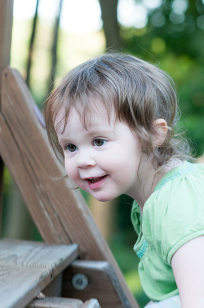 Young girl having fun on a swing setの写真素材