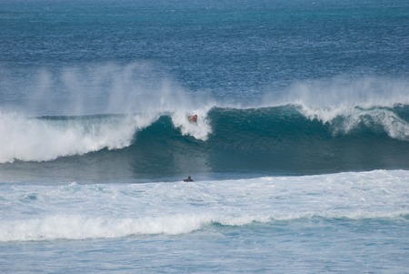 MAUI, HI - DECEMBER 8: Surfers ride a big waves in Maui on December 8, 2007のeditorial素材