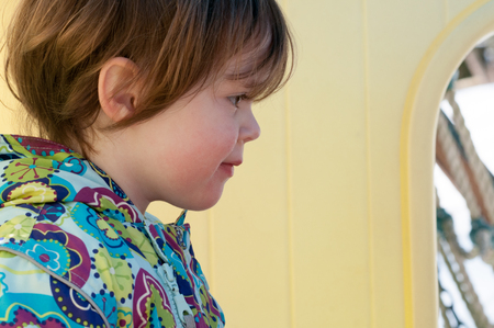 Happy toddler girl in warm coat on on snow day and having a fun in the winter outside, outdoor portraitの写真素材