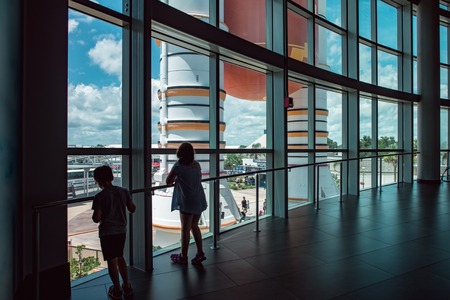 Cape Canaveral, Florida - August 13, 2018: Kids looking out at Atlantis Space Shuttle Rocket Booster at NASA Kennedy Space Centerのeditorial素材