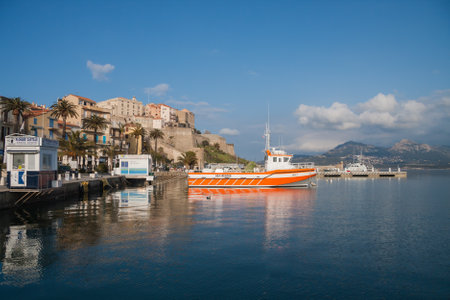 Calvi, Corsica, France March 4 2012: port of Calvi view with boats, buildings and mountains. Calvi is a popular tourist destination in Europe.のeditorial素材
