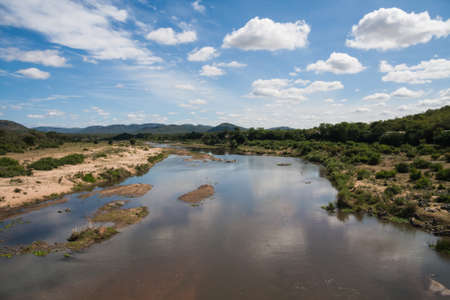 Scenic view from Malelane bridge at the entrance to Kruger National Park of the Crocodile river with cloud reflectionsの写真素材
