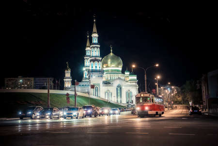 Evening view of the illuminated building of the Cathedral Mosque Madrasa, cars, tram and road, Moscow, Russia. Can be used for websites, brochures, posters, printing and design.のeditorial素材