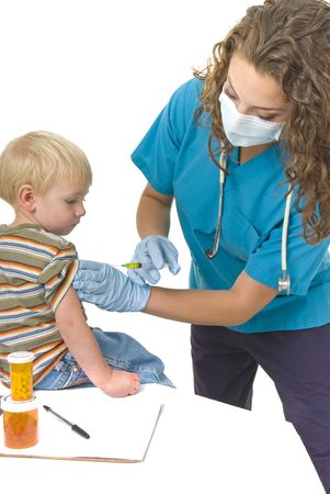 Health care professional gives needle to anxious little boyの写真素材
