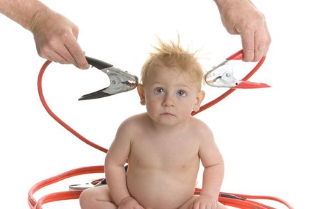 Baby with jumper cables held to head.  Brain power themeの写真素材