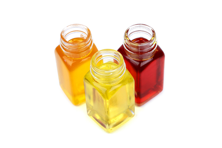 Castor oil, rosehip oil and mustard oil isolated on whiteの写真素材