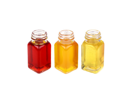 Castor oil, rosehip oil and mustard oil on white backgroundの写真素材