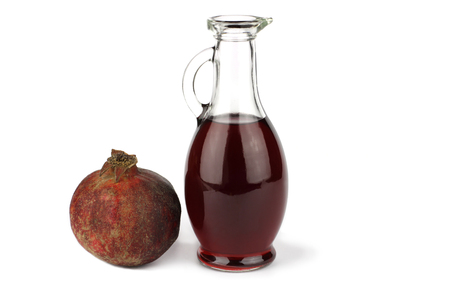 Garnet vinegar and whole pomegranateの写真素材