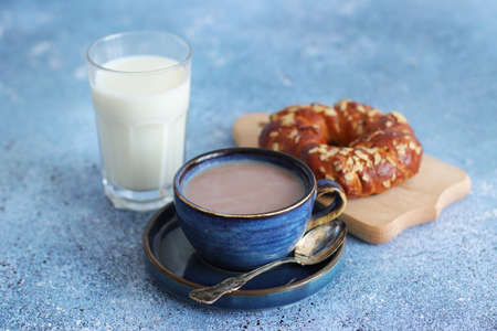 Coffee with milk and bun, healthy breakfast
