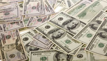 Large pile of US Currency: fifty dollar bills and one hundred dollar bills, photo taken view from...