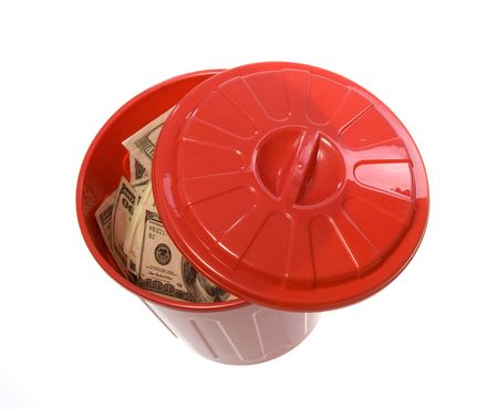 US Currency One Hundred Dollar Bills inside of a red garbage can with a lid next to it.   isolated on white background.の写真素材