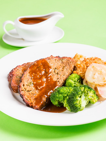 Meatloaf with vegetables and gravyの写真素材