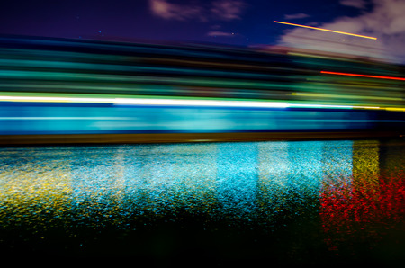 A slow shutter shot of a container ship passing by Savannah, Georgia late in the evening の写真素材